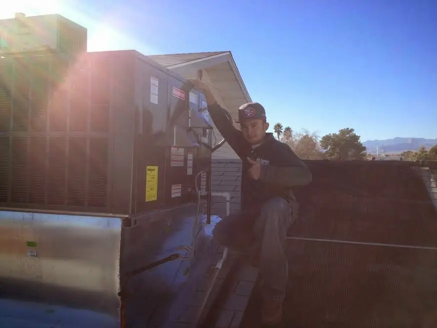 HVAC technician performing Air Duct Cleaning on a rooftop unit in Gahanna